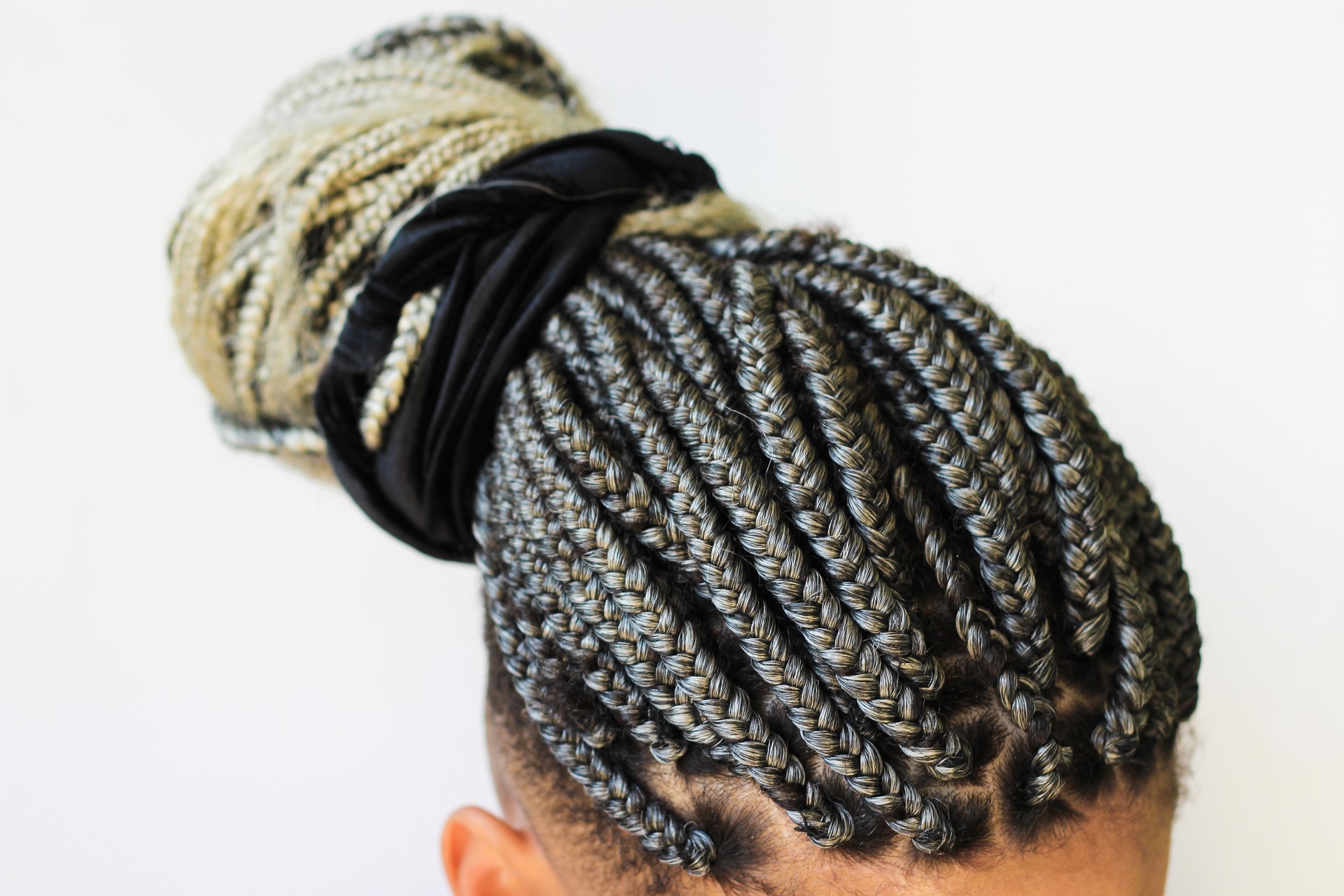 Young afro with blonde Box braids, African hair style also known as "Kanekalon braids." Close up on decoration and style.